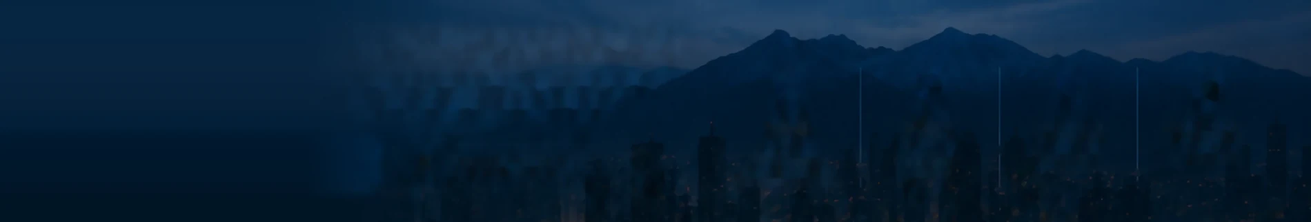 Cordillera y ciudad al anochecer